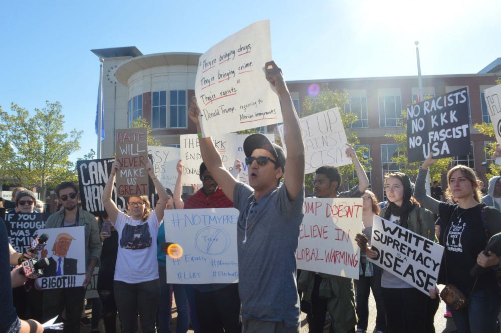 <p>A student of Latin decent holds a sign quoting president-elect Donald Trump. The young man, an immigrant himself, shared that he even paid out-of-pocket for classes. &nbsp;</p>