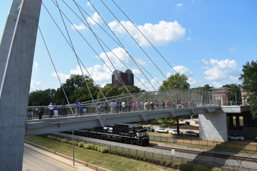<p>A first train passes under the bridge just after the official opening. University of Memphis administrators hope the bridge would stop students from hopping under and through stopped trains.</p>
