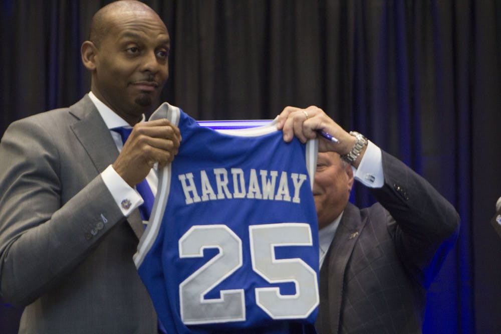 <p class="p1"><span class="s1">Penny Hardaway and Tom Bowen hold up Hardaway’s jersey from when he played at Memphis State University. Hardaway wore number 25 as a guard for Memphis.</span></p>