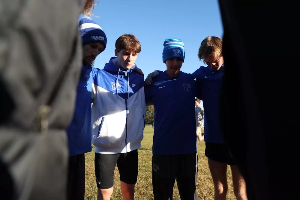 The Memphis men's cross country team huddles before the start of the American Conference Championship meet Saturday morning in Charlotte.