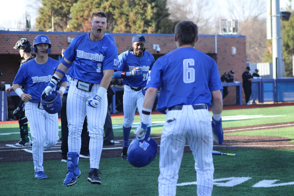 Jacob Compton (3) celebrates with Jake Curtis (6) after a three-run home-run in Memphis' game two victory over Wright State.
