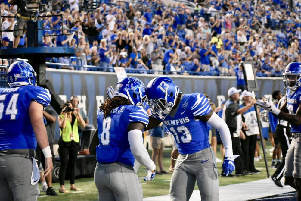 <p>Darrell Henderson and Kedarian Jones celebrate together. The Memphis Tigers beat the UConn Huskies and got their first conference win of the season</p>