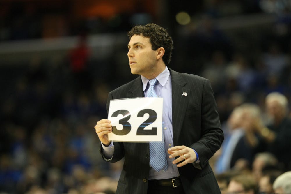 <p>University of Memphis coach Josh Pastner holding up a play last season. Pastner will return for his eighth season as coach of the Tigers next season.&nbsp;</p>