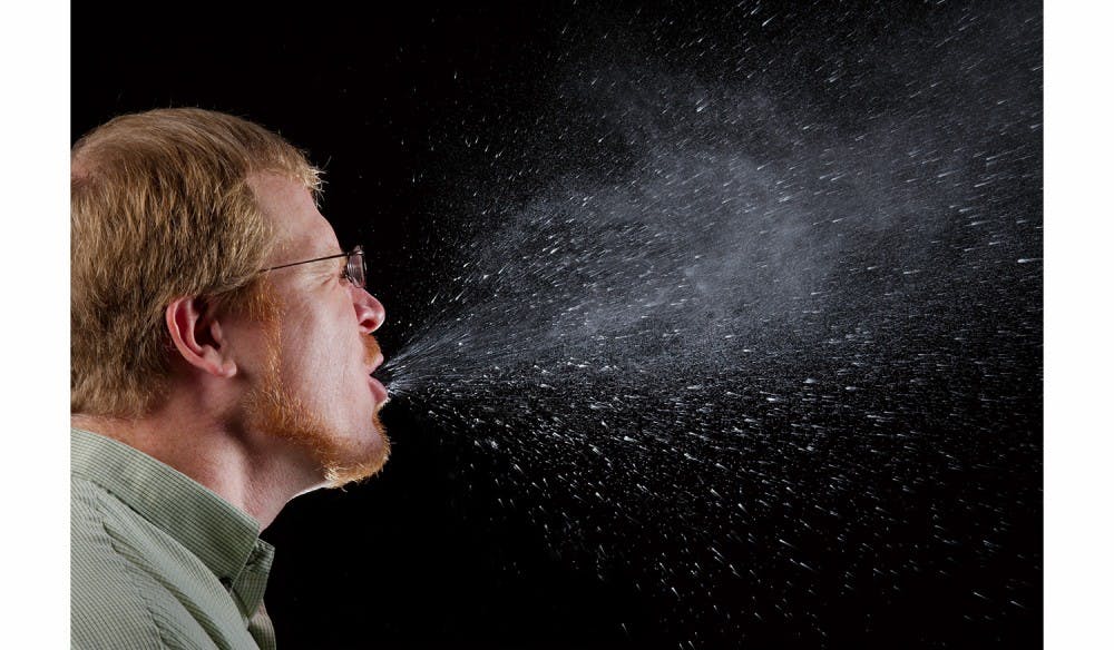 2009Brian JuddThis 2009 photograph captured a sneeze in progress, revealing the plume of salivary droplets as they are expelled in a large cone-shaped array from this manís open mouth, thereby, dramatically illustrating the reason one needs to cover hios/her mouth when coughing, or sneezing, in order to protect others from germ exposure.How Germs SpreadIllnesses like the flu (influenza) and colds are caused by viruses that infect the nose, throat, and lungs. The flu and colds usually spread from person to person when an infected person coughs or sneezes.How to Help Stop the Spread of GermsTake care to: - Cover your mouth and nose when you sneeze or cough -  Clean your hands often - Avoid touching your eyes, nose or mouth -  Stay home when you are sick and check with a health care provider when needed - Practice other good health habits.