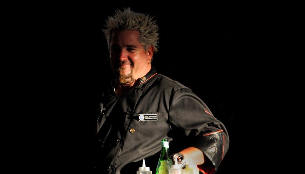 Guy Fieri, a Food Network cook and television personality, fires up the grill as he performs a cooking demonstration for more than 500 U.S. Sailors and their families at the Bloch Arena at Naval Station Pearl Harbor, Hawaii, Oct. 17, 2009. Fieri and his family are touring Pearl Harbor, the USS Arizona Memorial and Los Angeles-class submarine USS Greeneville (SSN 772) while in Hawaii to shoot an episode of ?Diners, Drive-ins and Dives.? (U.S. Navy photo by Mass Communication Specialist 2nd Class Mark Logico/Released)