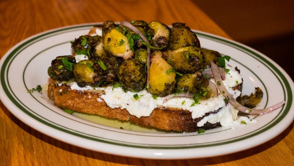 Toast laden with ricotta cheese and brussels sprout ceviche.jpg