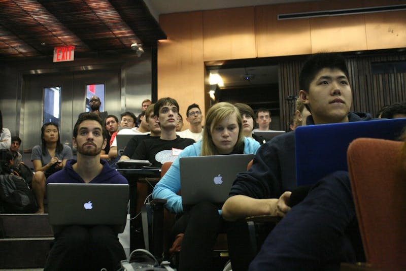 Student Working on Essay in Class Wishes She Could Turn Down Volume On Lecture