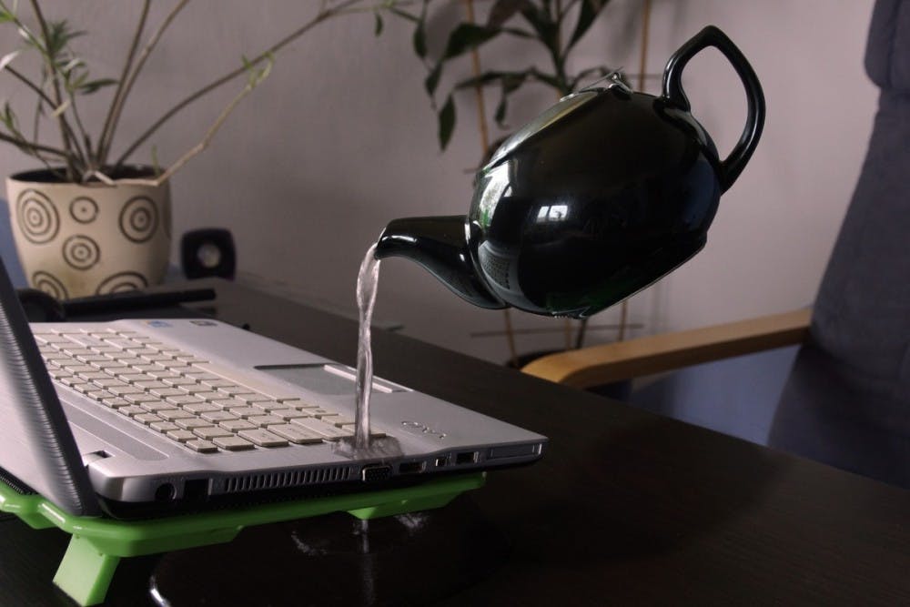 computer_kettle_laptop_pouring_water_water_damage_royalty_free_images-1033953