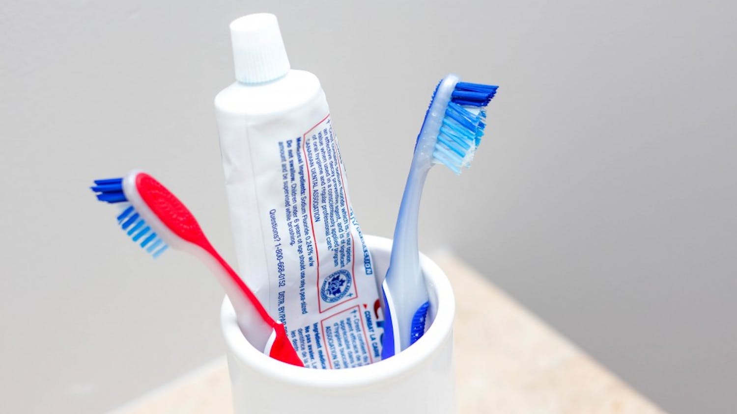 Toothbrush in a White Bowl with Toothpaste