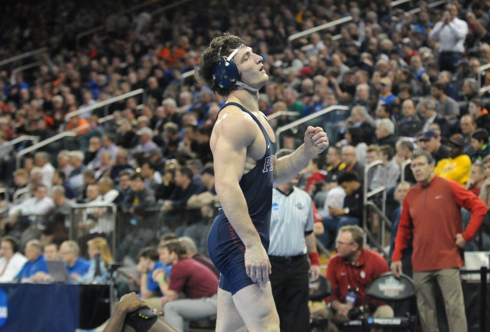 Senior 174-pounder Casey Kent celebrates after clinching All-American honors with a pin of Oklahoma's Matt Reed at the NCAA Championships.