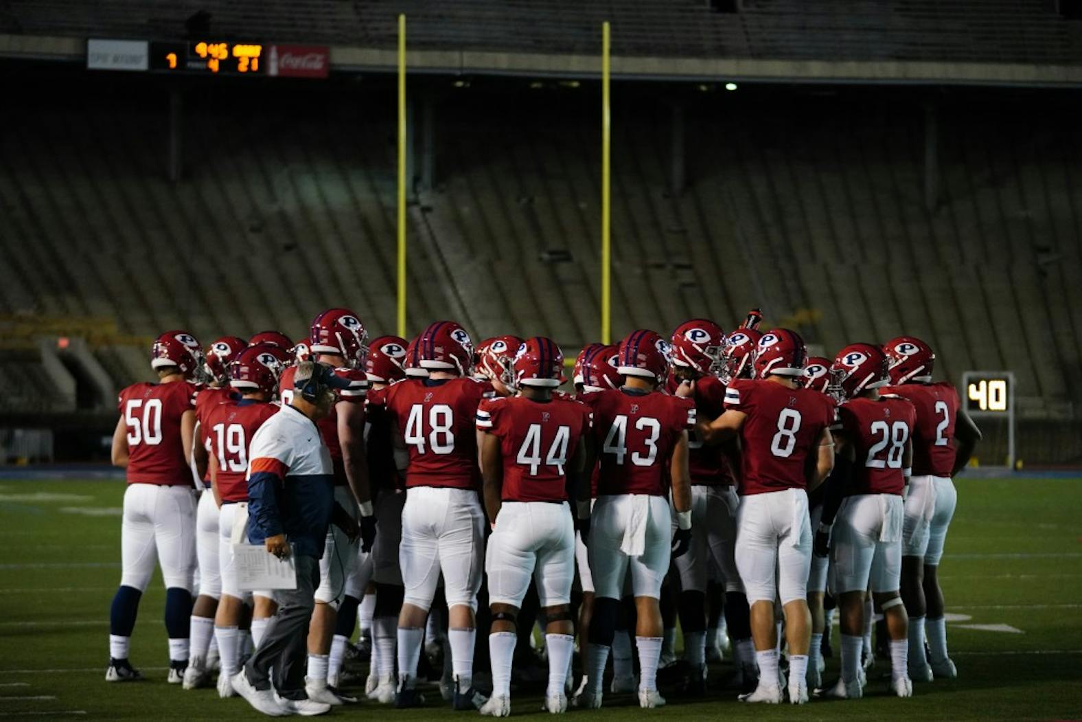 Football vs Dartmouth Team Huddle with uprights.jpg