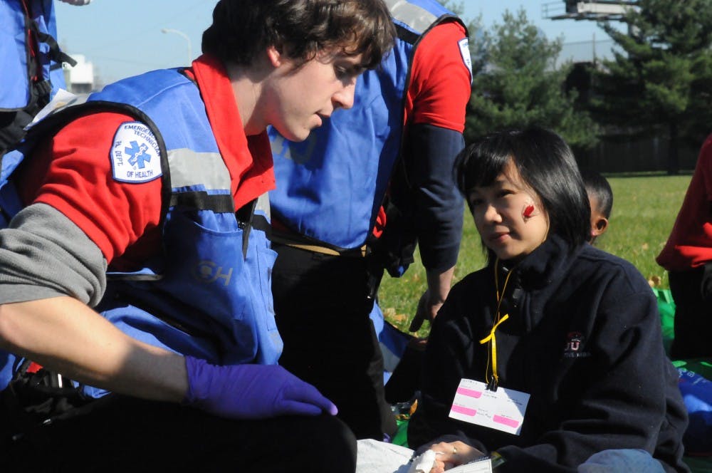 	MERT members respond to the mass casualty incident of a car and bus collision. The injured wore makeup and fake lacerations to make the simulation more realistic.