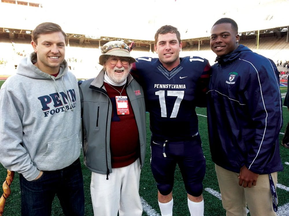 	(From left to right) Josh Powers, Bill Young, Dan Davis and Brandon Copeland stand together after the Homecoming game on Nov. 9 against Princeton. Young keeps in close contact with all three players writing emails at least once a week. Young is expecting Powers for a visit at his home in Rochester, N.Y., a trip that he used to make at least once a year with Penn football. 
