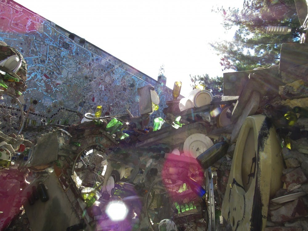 The many broken bottles comprised in the&nbsp;Magic Gardens on South Street shine in the setting sun.