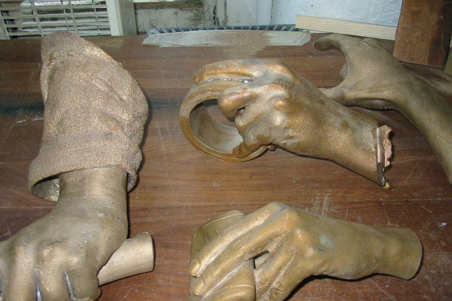 After getting them back from the foundry bright as gold, Lueders used a patina to give the hands their dark color.