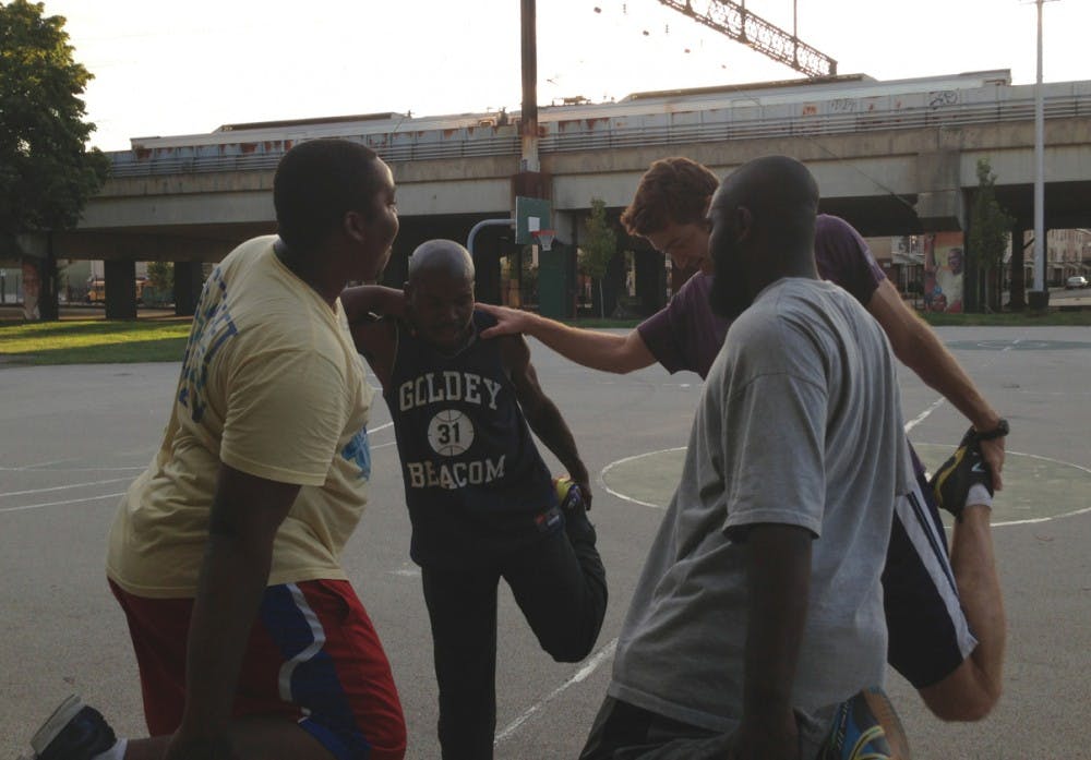 (From left to right) Reef Barclay, Walt Harris, coach John Salvucci and Ellish Danzy help each other at practice for Street Soccer Philadelphia, an organization committed to helping homeless youth and adults escape homelessness through team sport.   