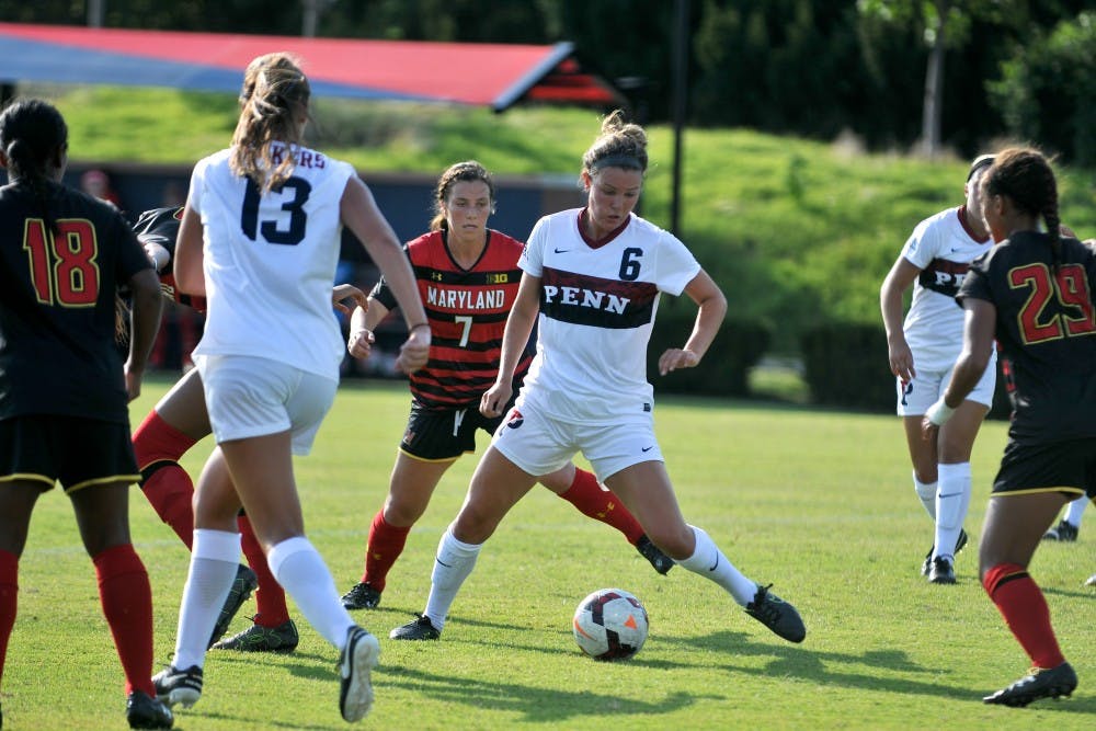 Junior Darby Mason weaves her way through Maryland and Penn players.