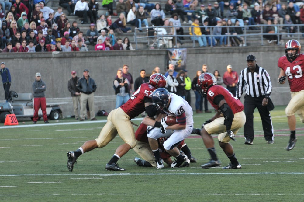 	Junior wide receiver Ty Taylor gets crushed by Harvard linebacker Jared Boyd during fourth-quarter action.