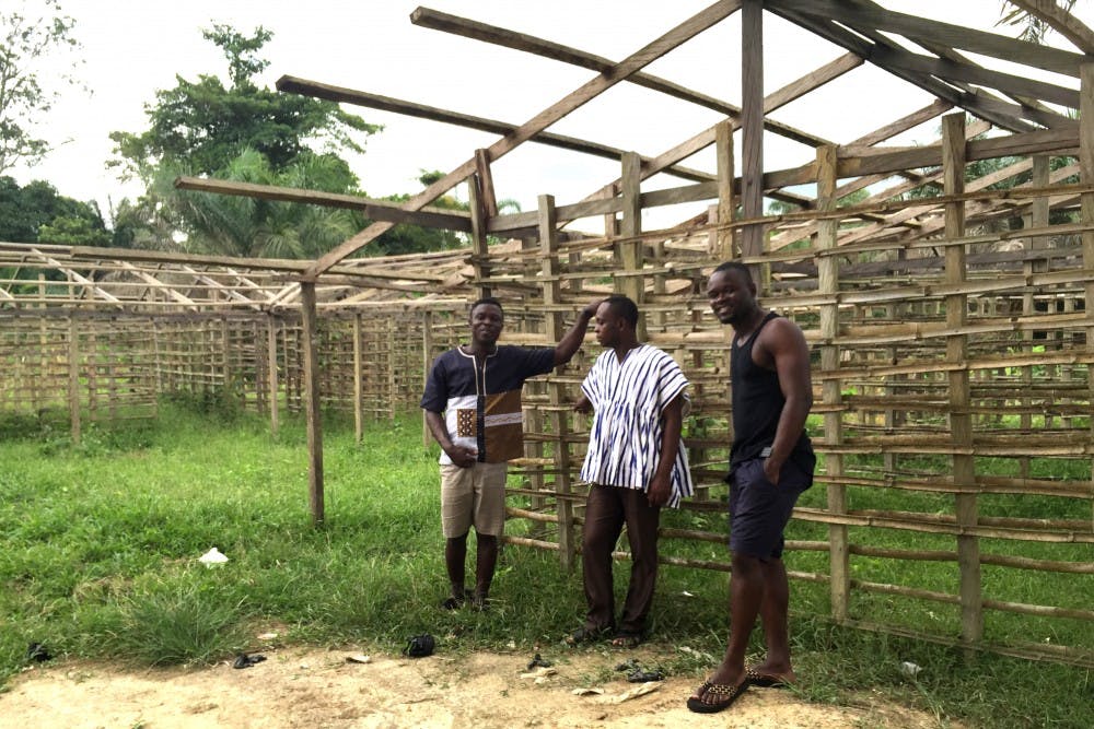 Shadrack Frimpong (left) standing alongside a work-in-progress building that is a part of his project to bring Tarkwa Breman a model school for girls and a community clinic. |&nbsp;Courtesy of Tarkwa Breman Community Alliance