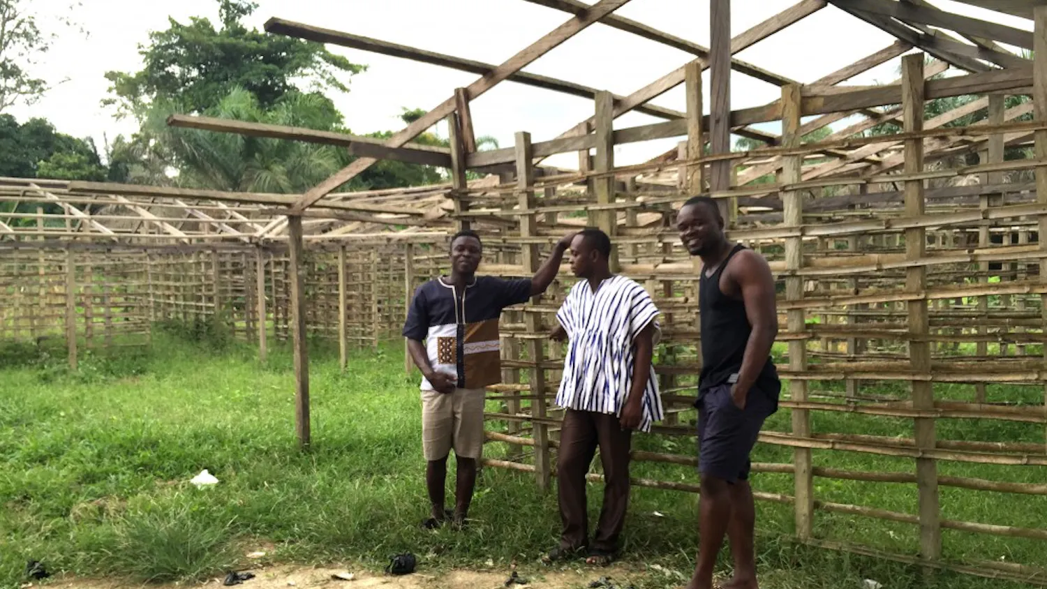 Shadrack Frimpong (left) standing alongside a work-in-progress building that is a part of his project to bring Tarkwa Breman a model school for girls and a community clinic. | Courtesy of Tarkwa Breman Community Alliance