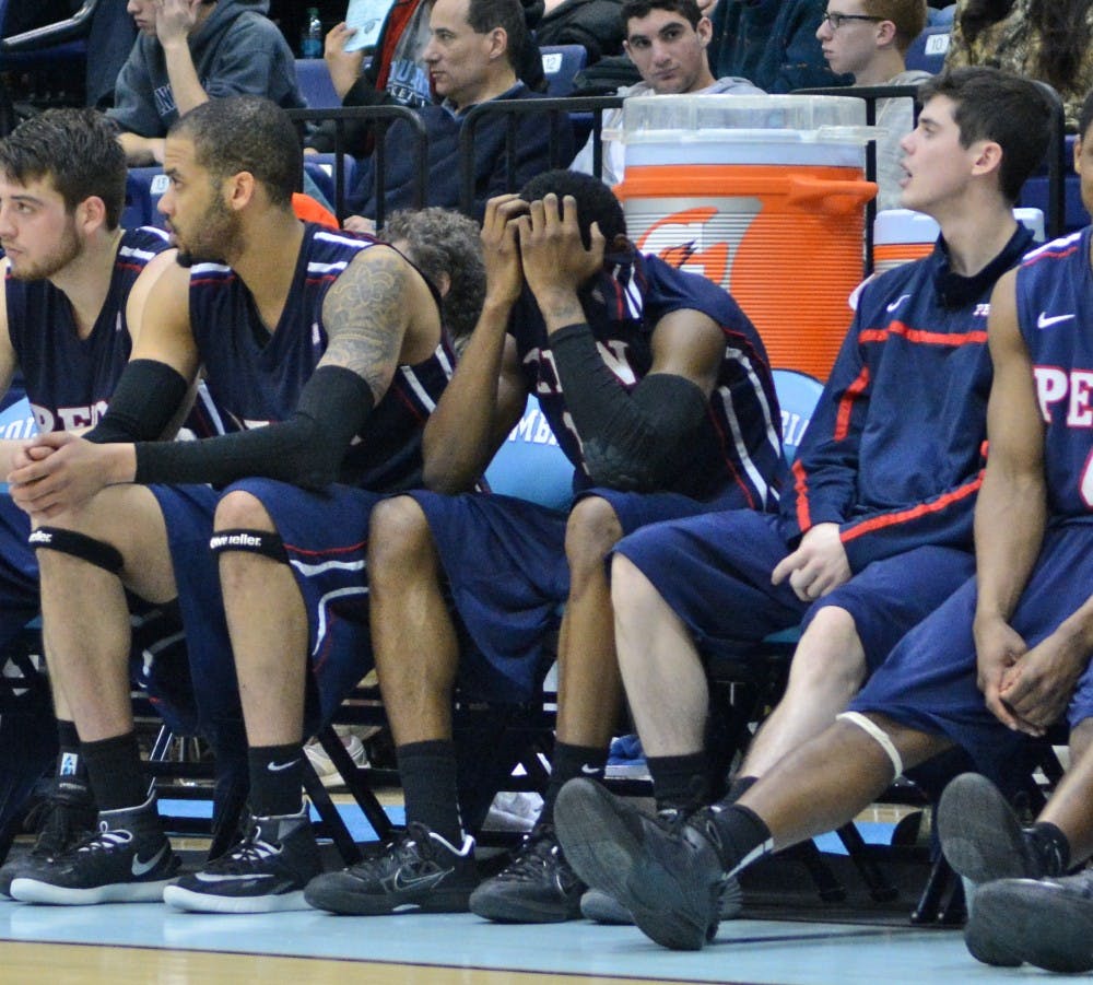 Sophomore guard Tony Hicks could only hang his head before getting removed from the bench on Friday night. Hicks was ejected for throwing a punch during the Quakers' 74-55 loss at Columbia.