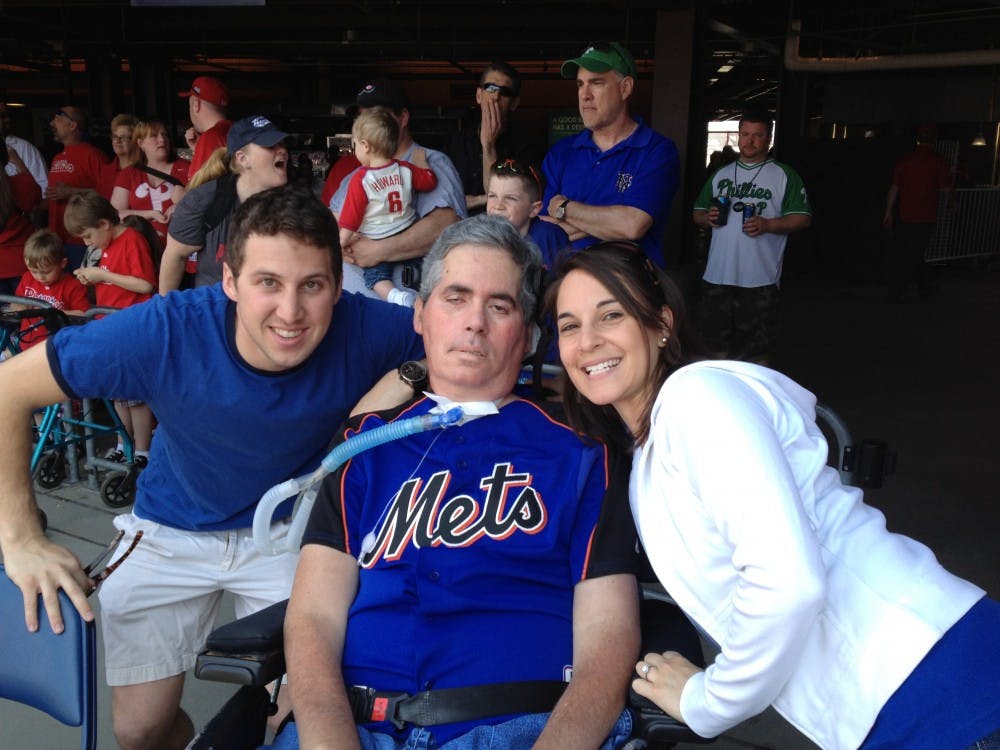 	Scott Mackler attends a New York Mets game with his son, Noah, and friend, Jen.