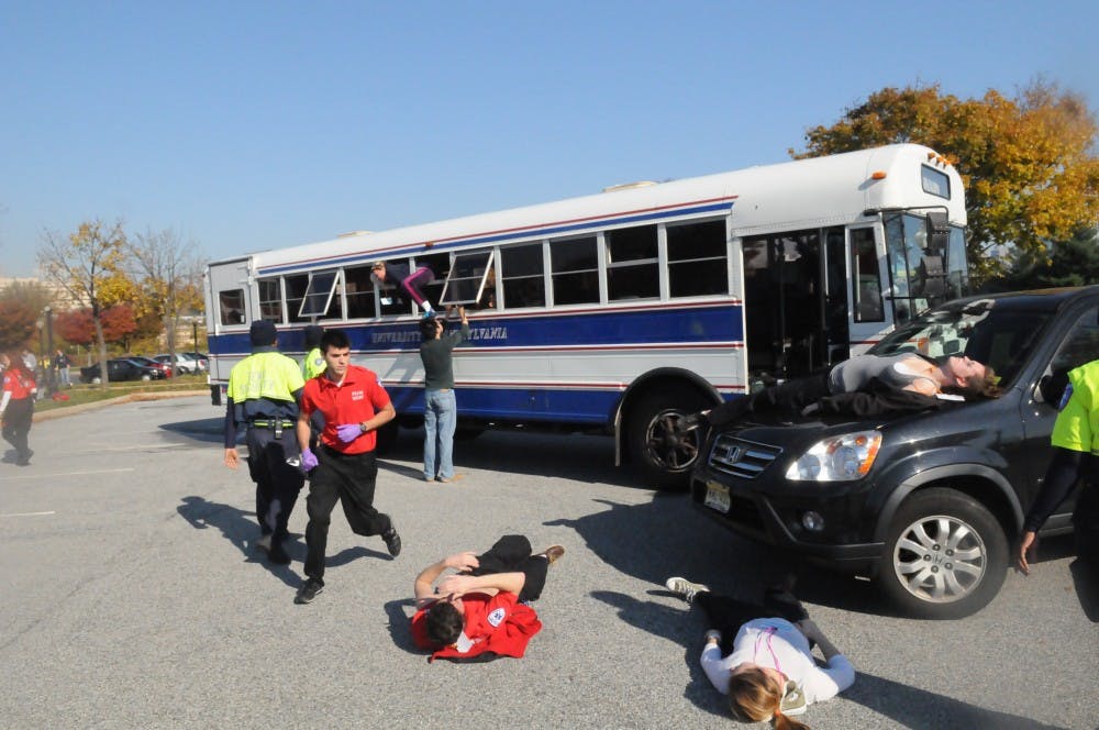 	MERT members respond to simulated mass casualty incident of a car and bus collision. The injured wore makeup and fake lacerations to make the simulation more realistic.