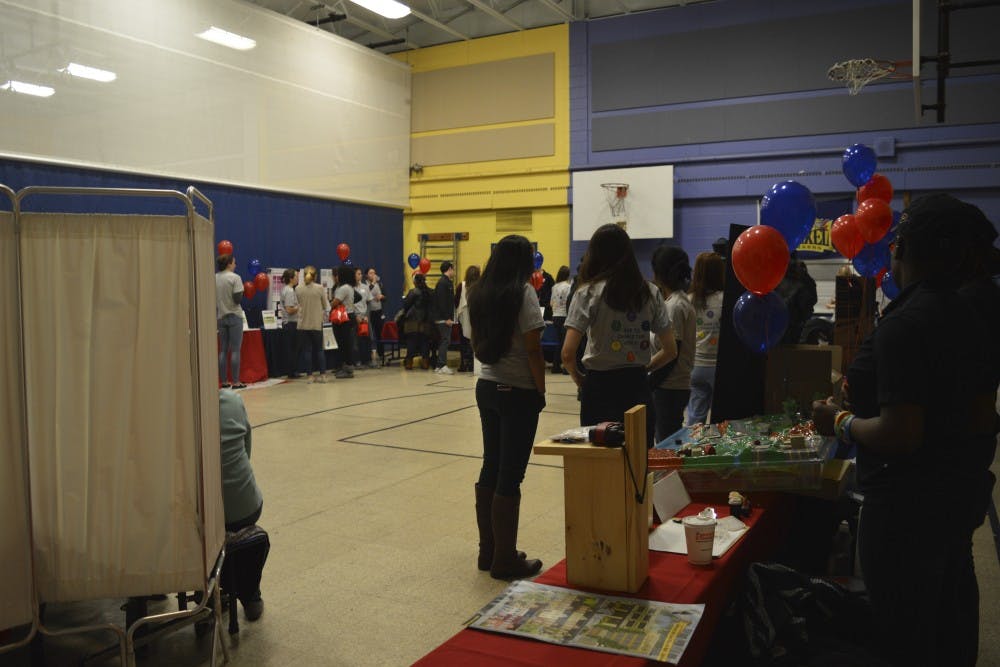 Attendees received physical handbooks as they checked in, and volunteers filled in their health information as they went through the fair.