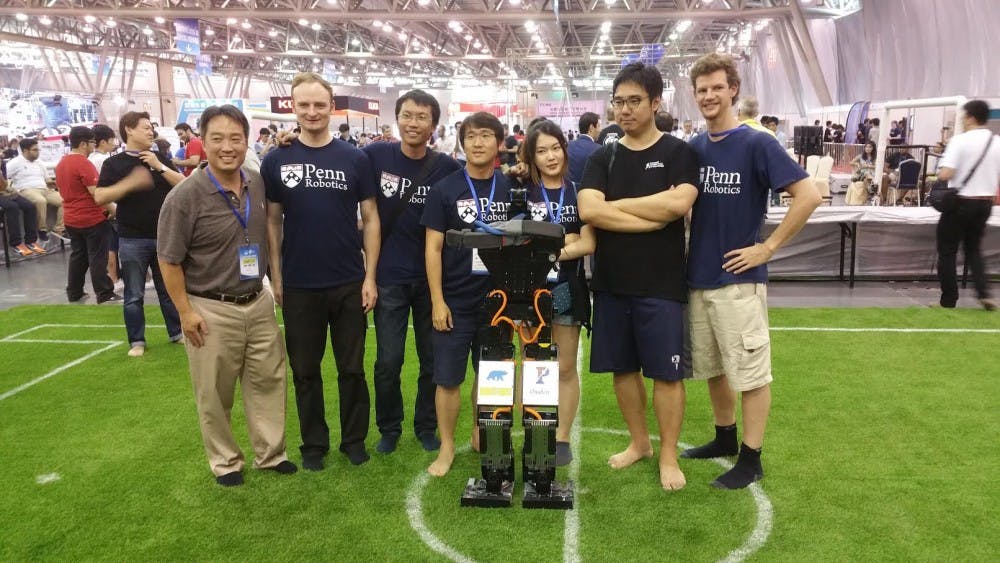 Penn's robots beat out Iran for the championship in the annual Robocup World Finals this summer. From left to right: Professor Dan Lee and team members Marcell Missura, Jianqiao Li, Jinwook Huh, Heejin Jeong, Seung Joon Yi, Stephen McGill.