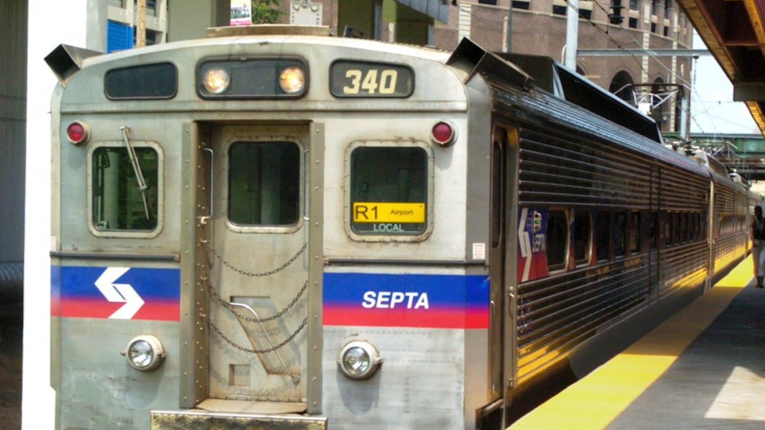 An R1 regional rail train heads toward the airport.