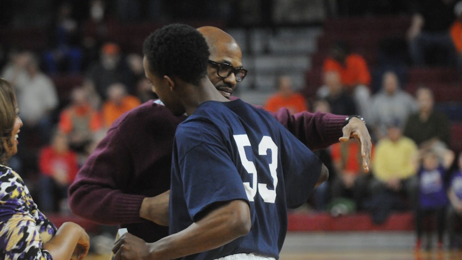 Head coach Jerome Allen greets Cameron Crocker at mid-court before Tuesday's Ivy League matchup with Princeton during senior night festivities. By Thomas Munson