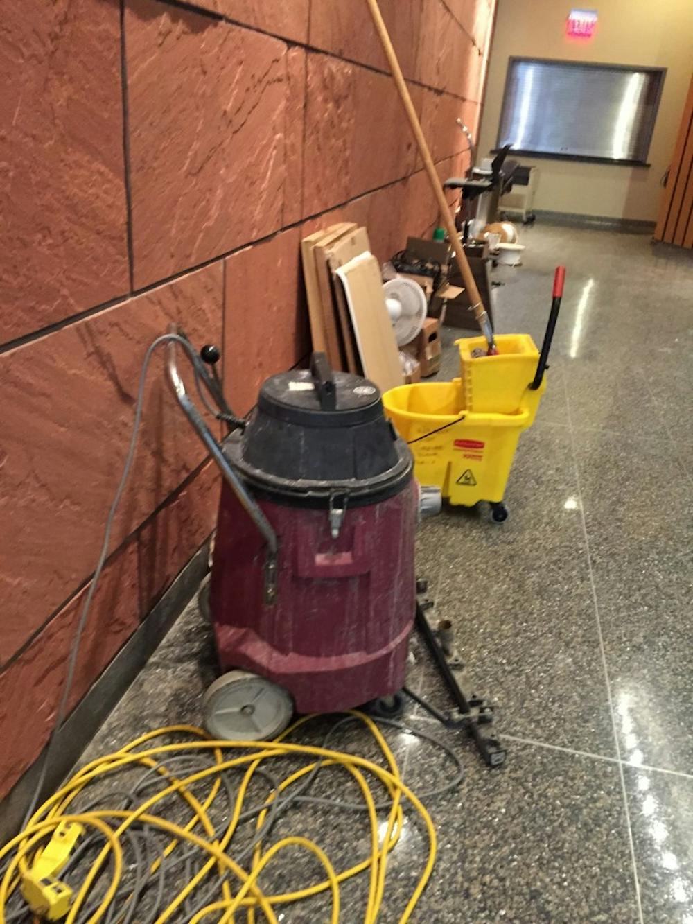 Maintenance equipment lined the wall near the Walnut Street entrance as of press time, including electrical cords, a bucket with a mop and a fan.