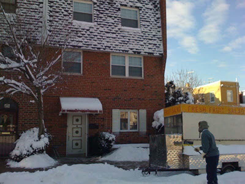	Don Ly cleans off his fruit truck in front of his Vollmer Street home in South Philadelphia.