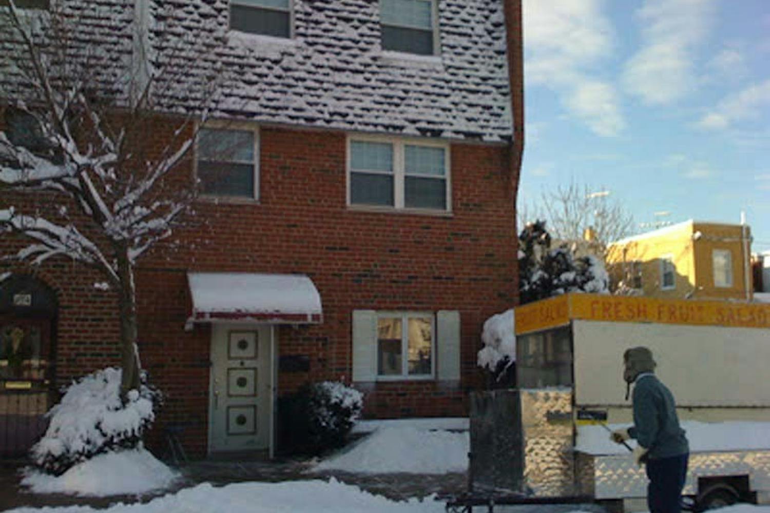 Don Ly cleans off his fruit truck in front of his Vollmer Street home in South Philadelphia.