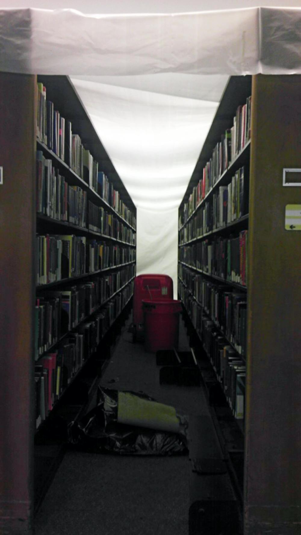 	Bookshelves in the Biomedical library were put under a plastic cover to protect from further water damage.