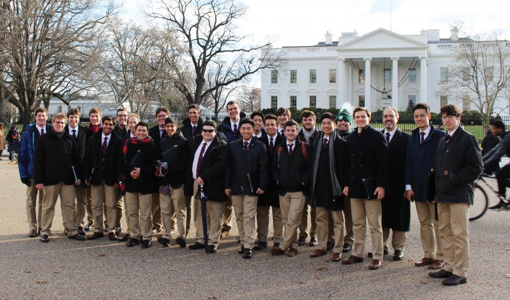 The Penn Glee Club poses in front of The White House, where they performed.