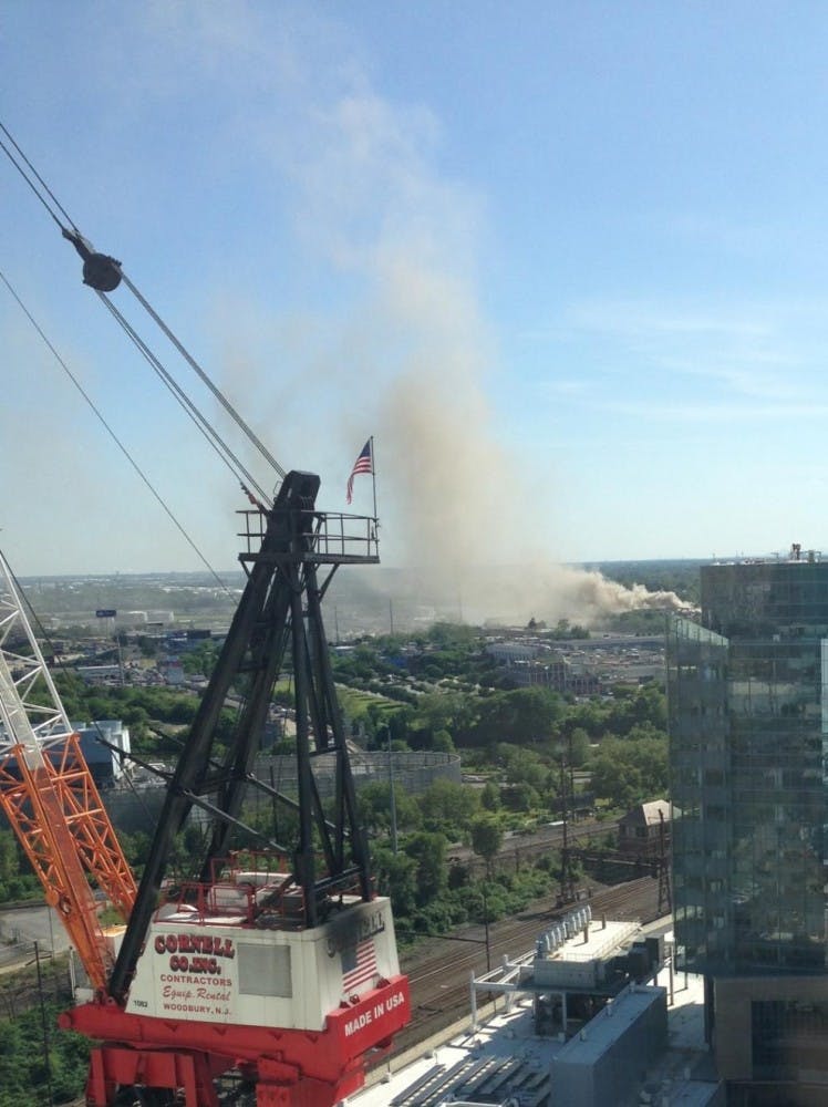 	Thick smoke rises from a fire at a junkyard at 1620 S. 49th St., as seen from the Smilow Research Center. 