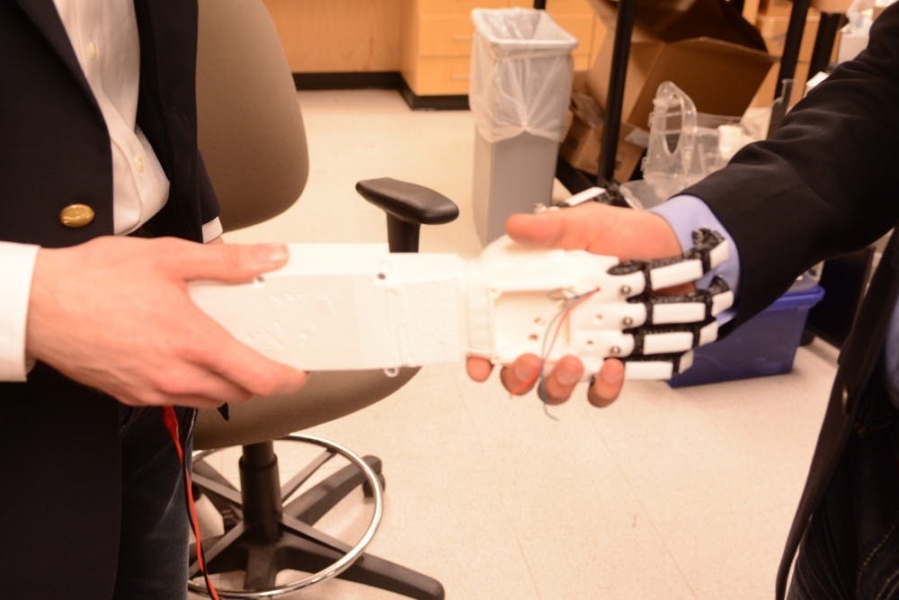Team members Matthew Lisle and Adrian Lievano demonstrated a prototype of the arm which, among other things, can shake hands.