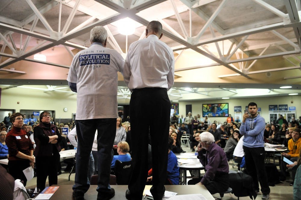 A supporter for Bernie Sanders speaks to the room in an attempt to sway the undecided caucus goers to support Sanders.