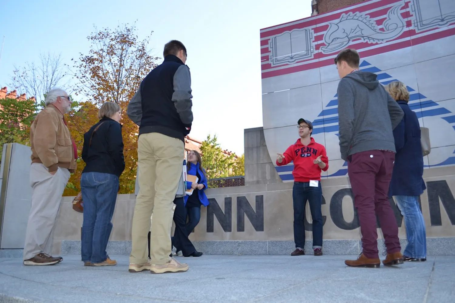 College senior Travis Mager leads a tour outside Houston Hall on Monday. Due to the SAC moratorium, campus tour guides are changing what they tell visitors.