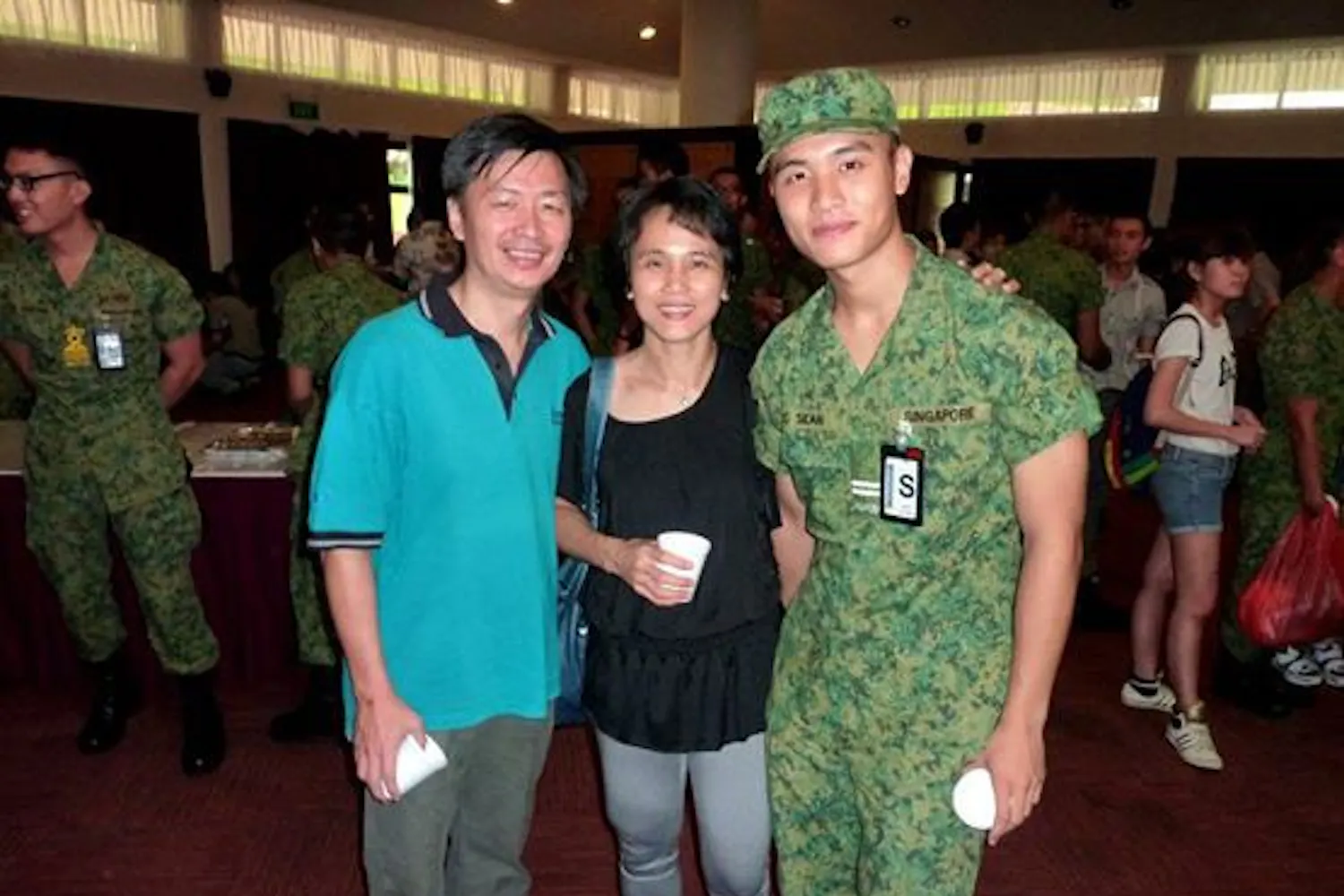 Ying Cong Seah with his parents in Singapore Armed Forces uniform.