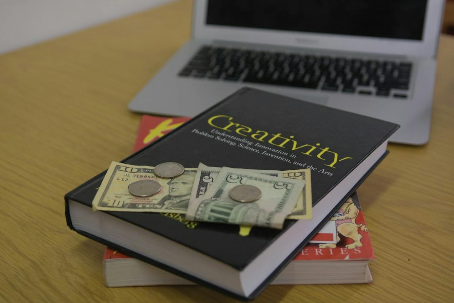 Penn professors, administrators, and students alike struggle with the issue of hidden course fees and the tremendous cost of textbooks for each class.