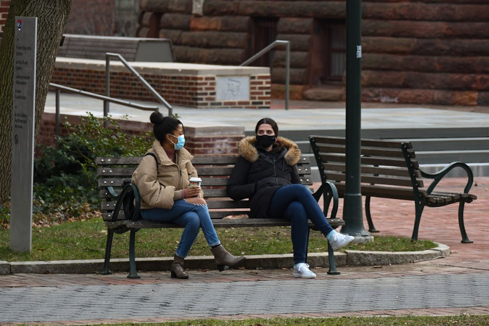 socially-distant-wearing-masks-bench-covid-19-pandemic-spring-coffee-friends-colleagues-campus-locust