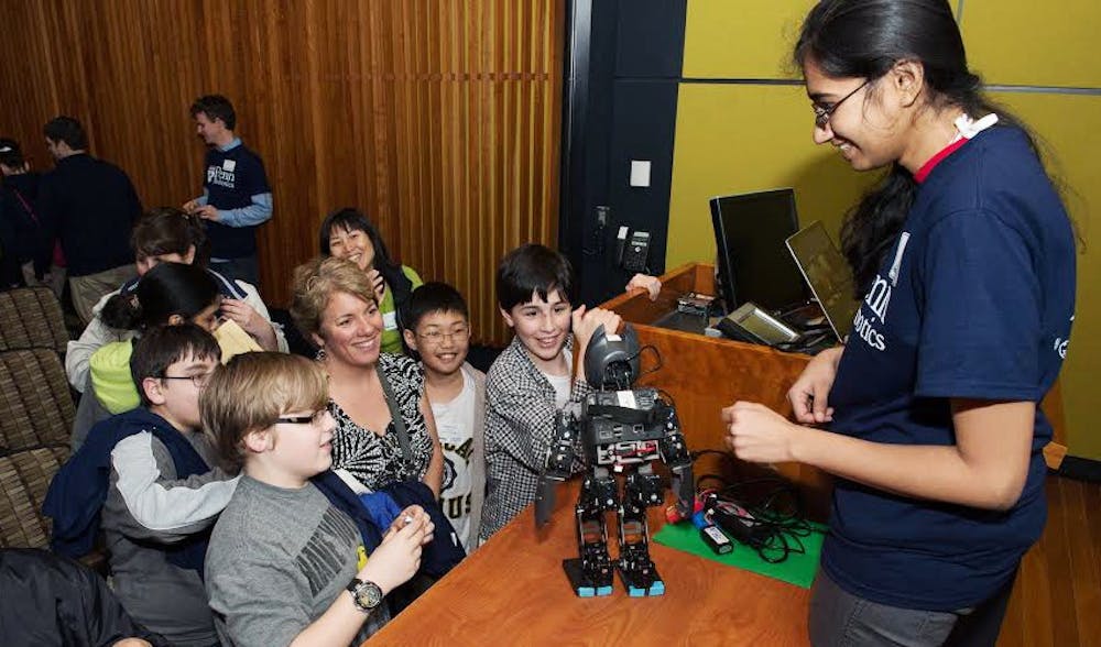 Student mentor Richa Agrawal interacts with children at the Philly Robotics Expo. 