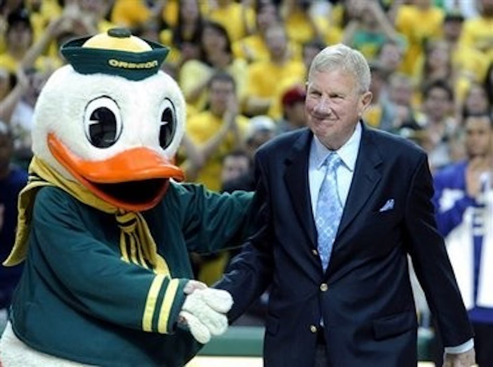 	Former Oregon and Penn basketball coach Dick Harter poses with the Oregon Duck. Jim Wolf coached under Harter at Oregon in the early 1970s.