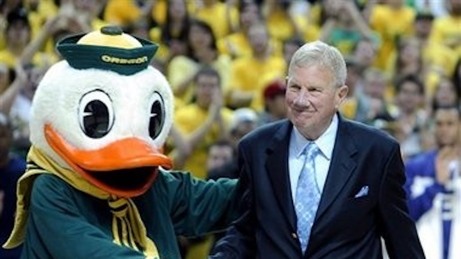 Former Oregon and Penn basketball coach Dick Harter poses with the Oregon Duck. Jim Wolf coached under Harter at Oregon in the early 1970s.