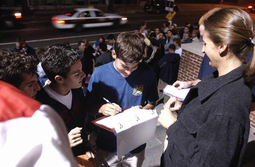 Hundreds of Quaker fans line up in front of Pottruck center to be first to receive bracelets allowing them to purchase season basketball tickets.  The time and location of this event wasn't disclosed until moments before the actual bracelets were given out.
