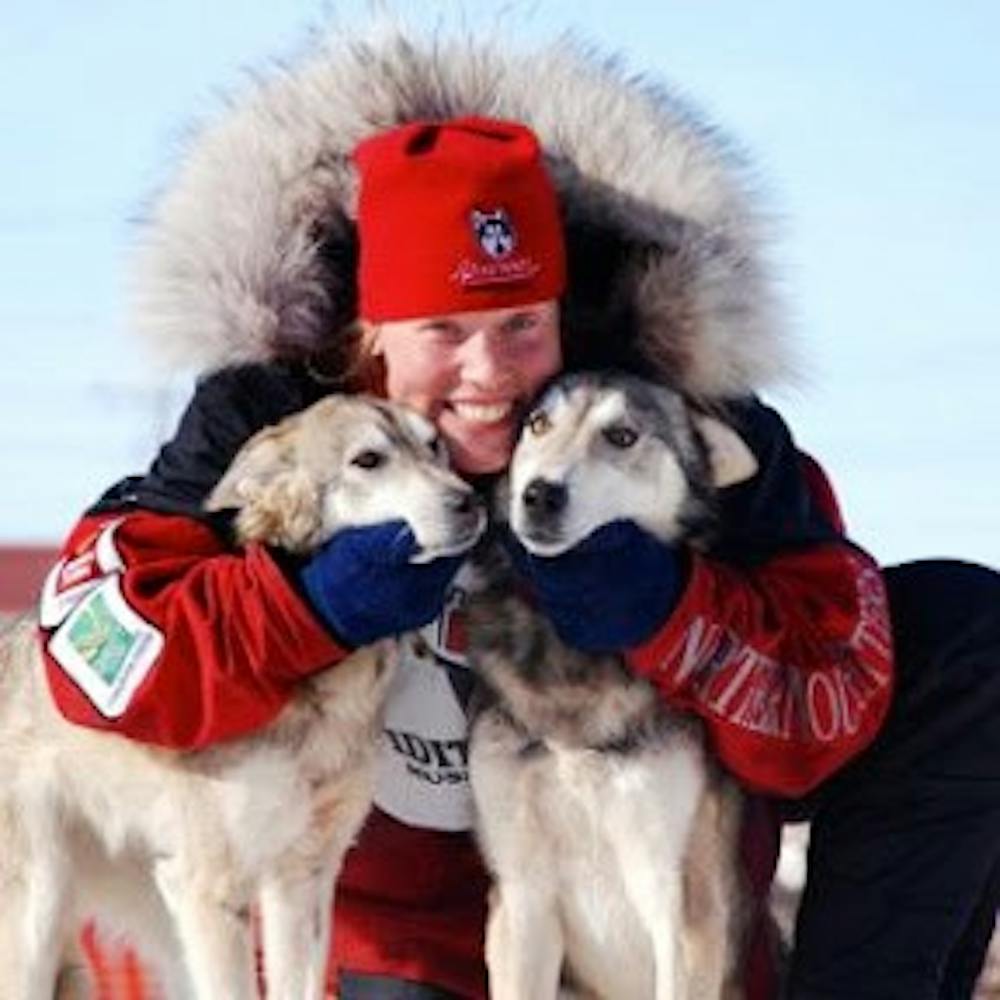 	1992 College graduate Aliy Zirkle poses with two of her dogs. 