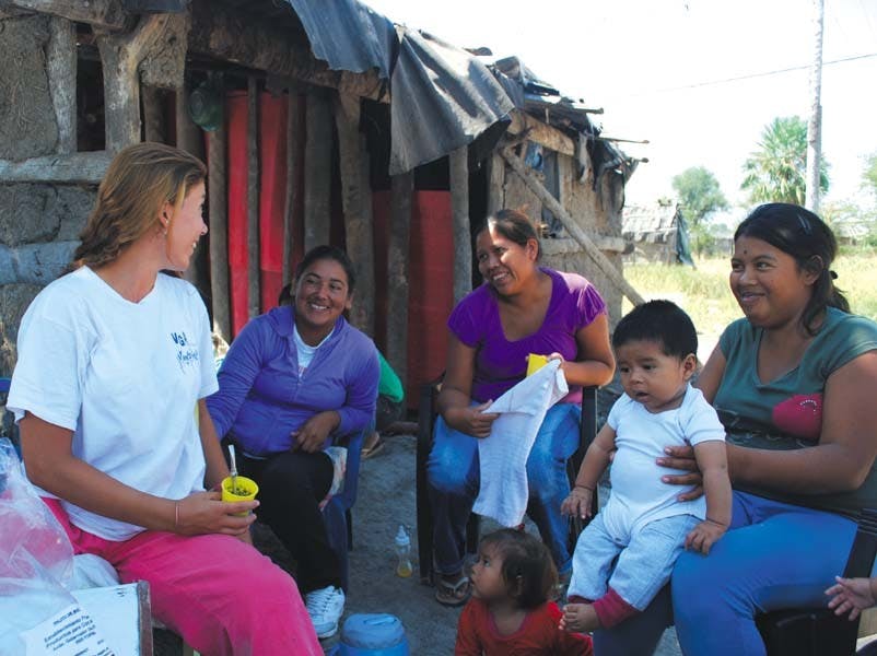 	Claire Stingley (left), a 2012 College graduate, talks with a field assistant and two mothers who are participating in the Fundación ECO’s study on babies and fertility. The Fundacion was founded by two Penn professors in 1999.
