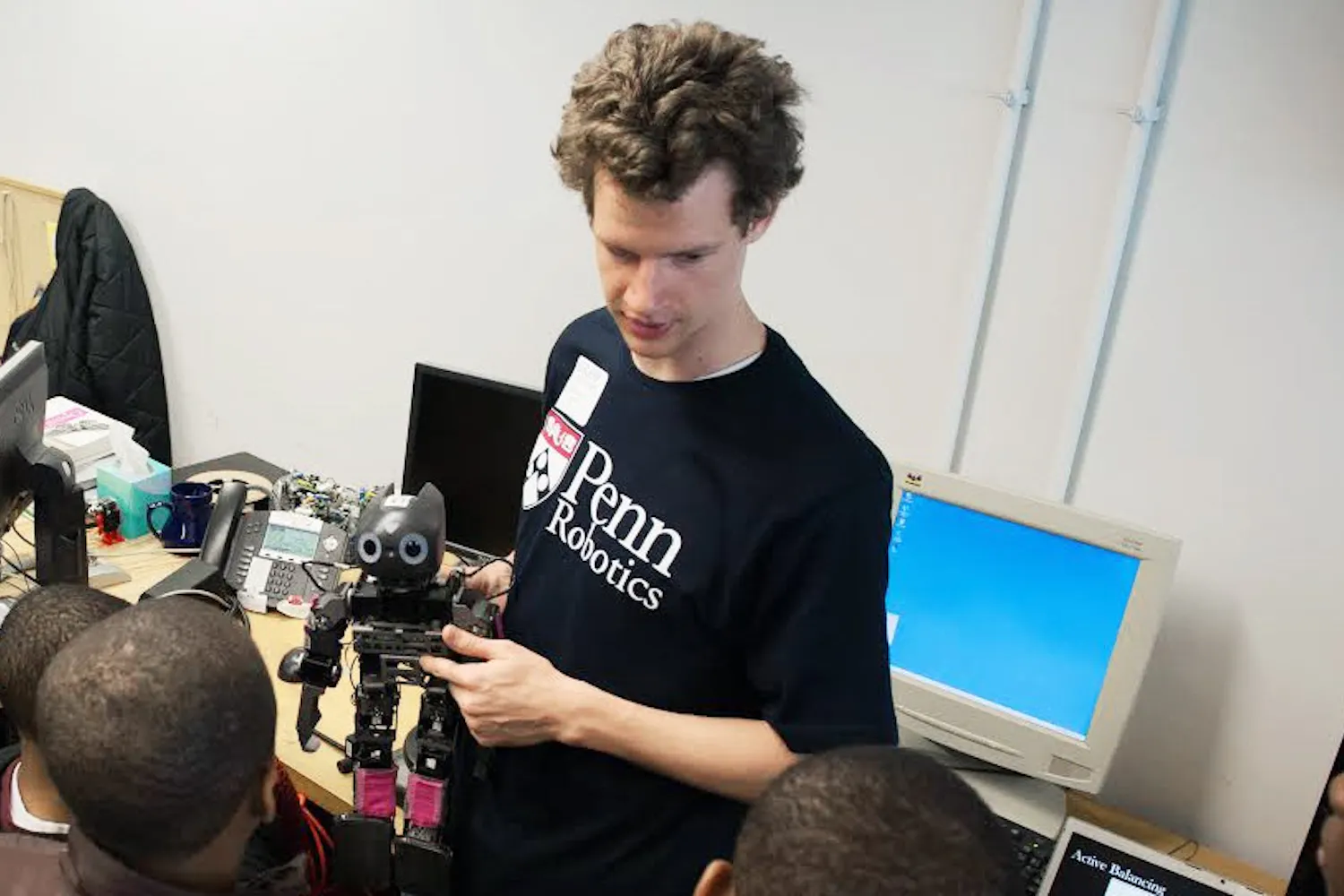 Student mentor Stephen McGill gives a tour of the GRASP Laboratory.